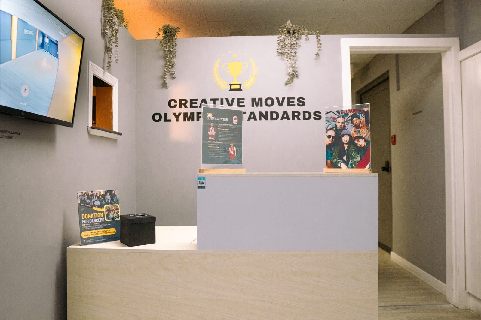 The reception desk in the entrance, with the studio's tagline on the wall behind it.